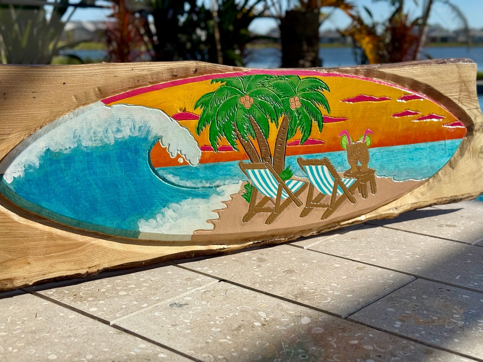 Sippin' Sunsets live-edge ash wood carving with a breaking wave, palm trees, beach chairs, and a tropical sunset